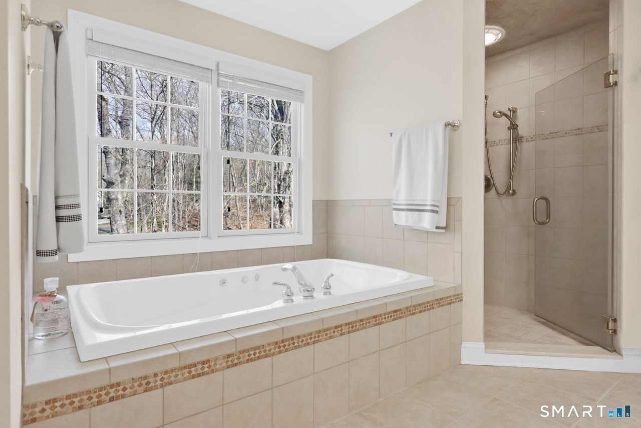 1 Bramble Trail Newtown, CT 06470 - Photo 18 of 31 a bathroom with a bathtub and a shower