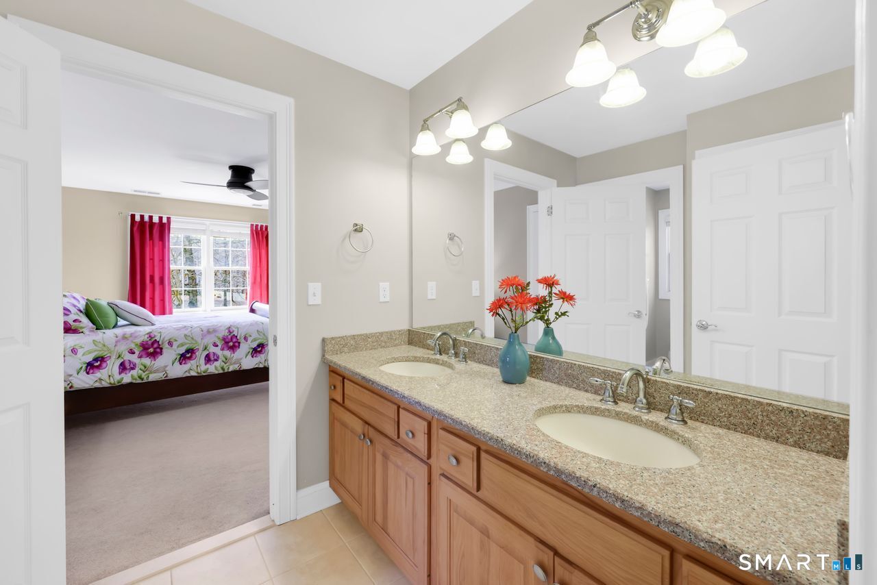 1 Bramble Trail Newtown, CT 06470 - Photo 20 of 31 a bathroom with a granite countertop sink a large mirror and a shower