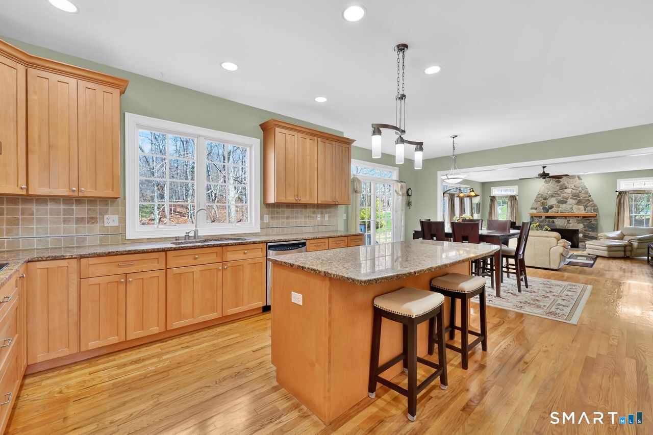 1 Bramble Trail Newtown, CT 06470 - Photo 9 of 31 a kitchen with stainless steel appliances granite countertop a kitchen island a stove and a sink