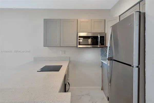 a kitchen with a refrigerator and a microwave