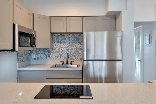 a kitchen with a refrigerator and a sink