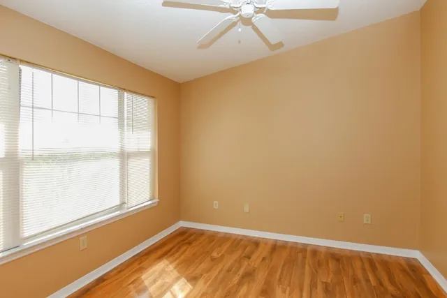 a view of an empty room with a window and closet