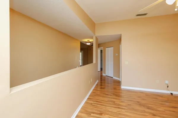 a view of a hallway with wooden floor