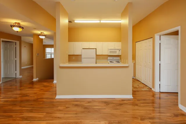a view of a kitchen from a hallway