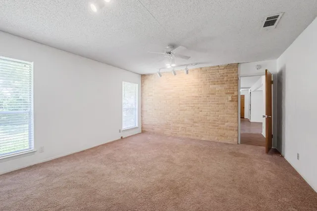 an empty room with a cabinet and a window