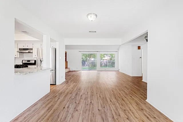 a view of a room with wooden floor and a window