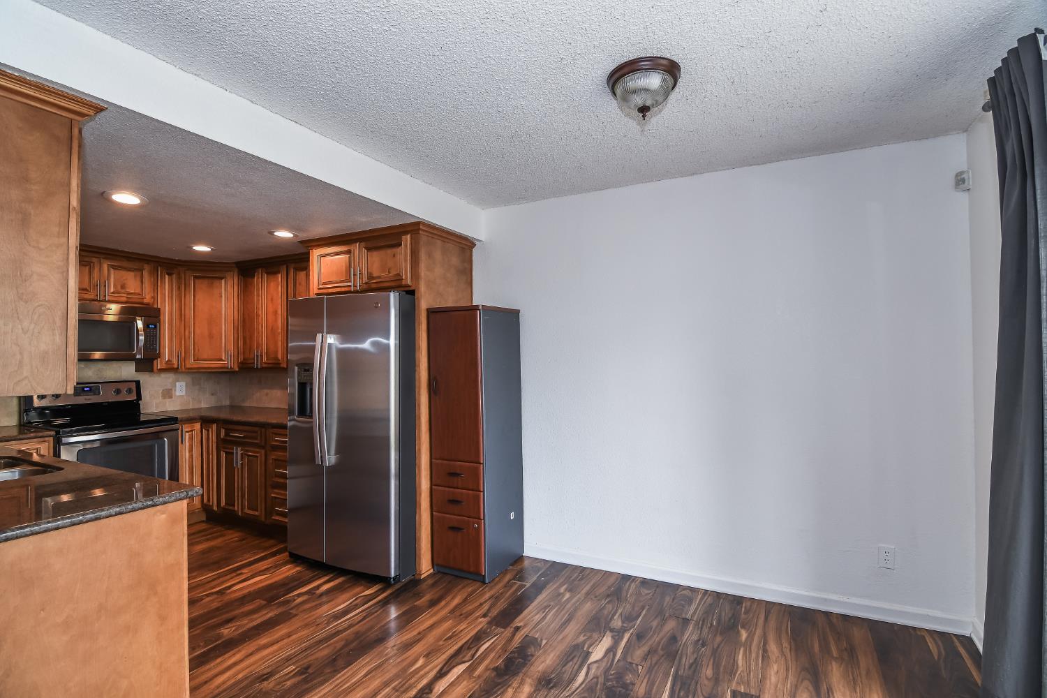 1139 Rivara Circle Sacramento, CA 95864 - Photo 17 of 72 a kitchen with stainless steel appliances a refrigerator and wooden floor