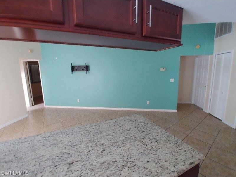 17245 Lee Road Fort Myers, FL 33967 - Photo 8 of 11 a view of a kitchen with refrigerator and cabinets