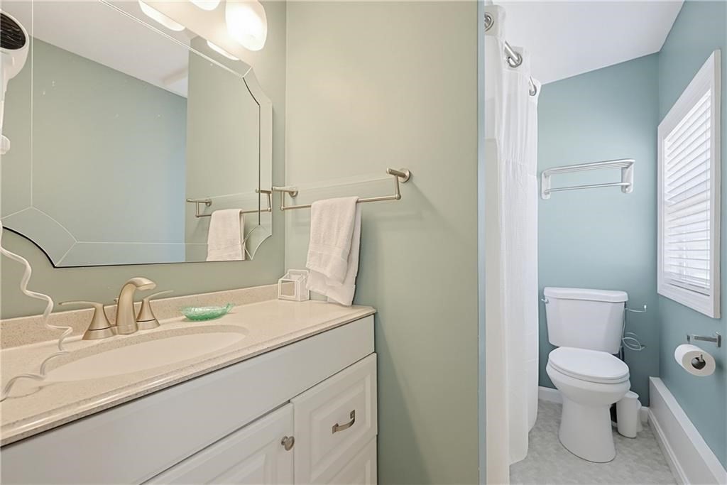 271 Great Island Road, Unit G Narragansett, RI 02882 - Photo 11 of 25 a bathroom with a sink toilet and vanity