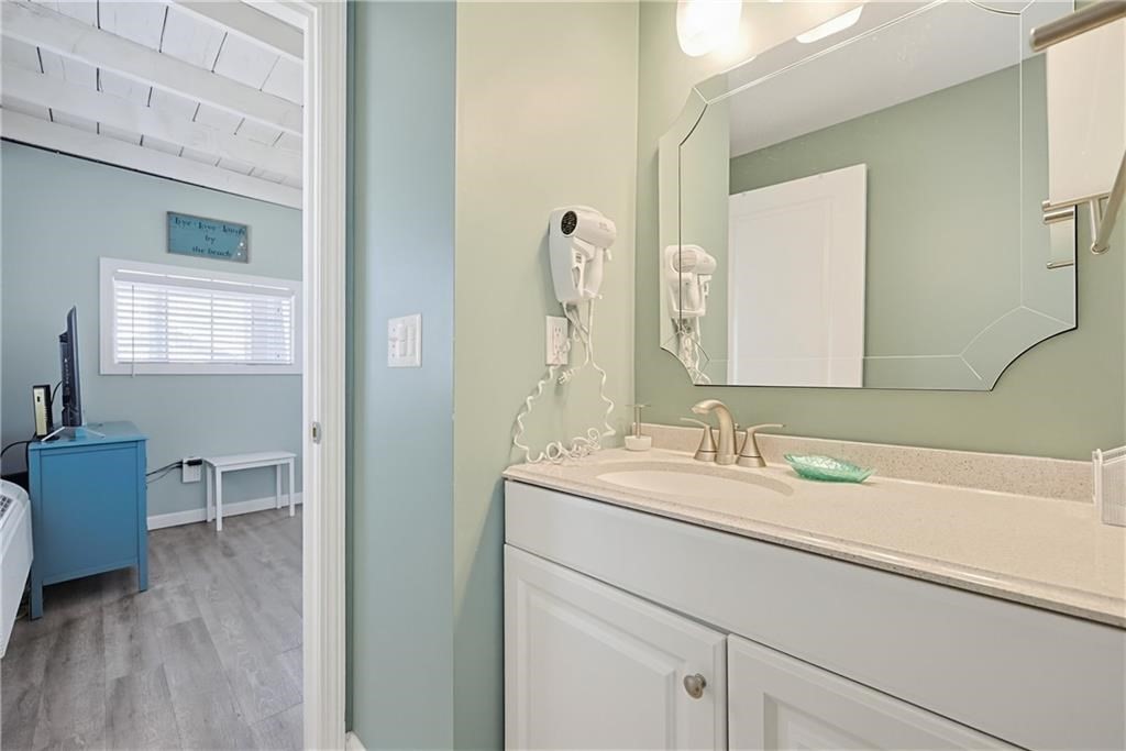 271 Great Island Road, Unit G Narragansett, RI 02882 - Photo 12 of 25 a en suite bathroom with a double vanity sink a mirror and a