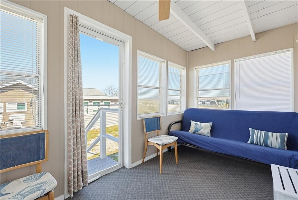 271 Great Island Road, Unit G Narragansett, RI 02882 - Photo 19 of 25 a living room with furniture and a floor to ceiling window