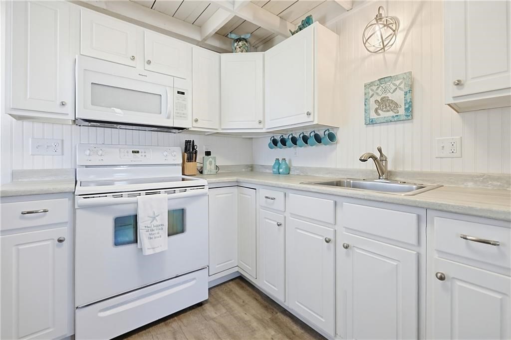 271 Great Island Road, Unit G Narragansett, RI 02882 - Photo 4 of 25 a kitchen with white cabinets and white appliances