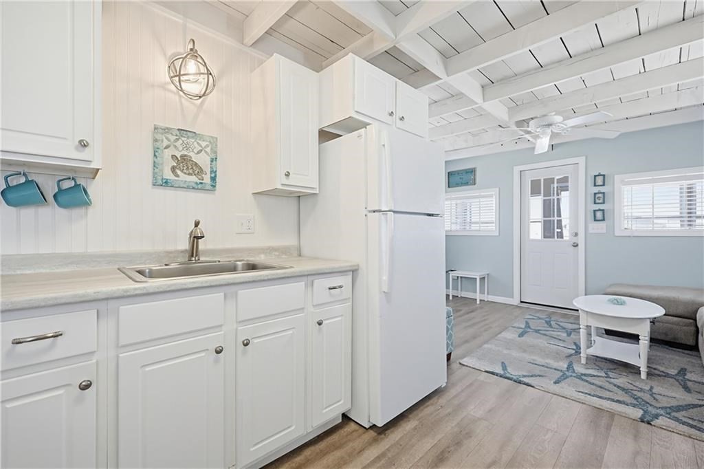 271 Great Island Road, Unit G Narragansett, RI 02882 - Photo 5 of 25 a kitchen with cabinets and wooden floor