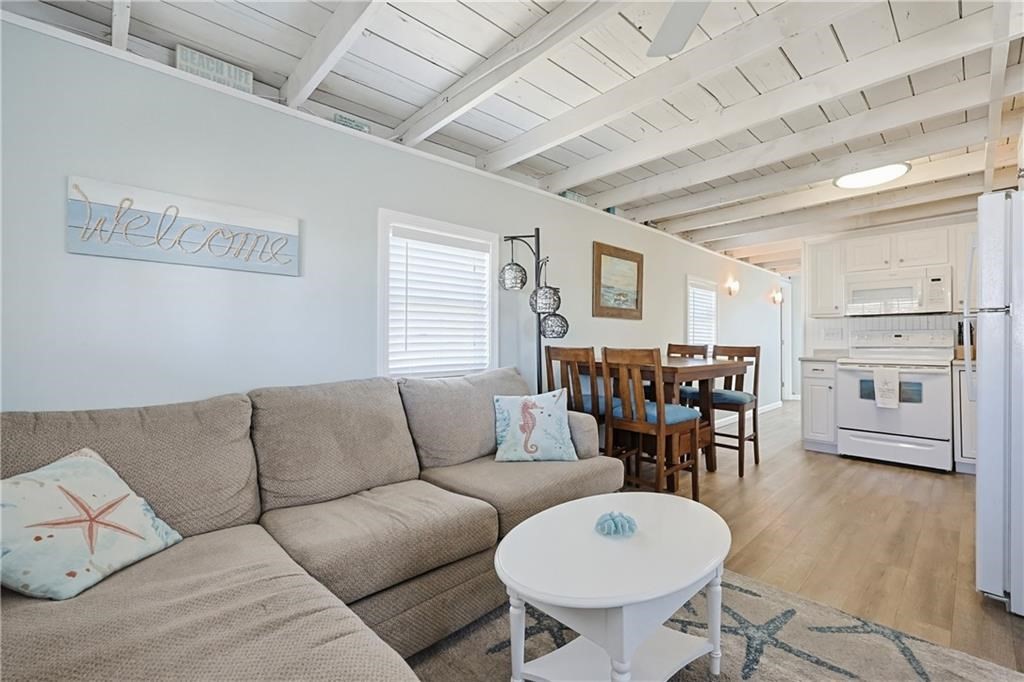 271 Great Island Road, Unit G Narragansett, RI 02882 - Photo 9 of 25 a living room with furniture a dining table and chairs with wooden floor