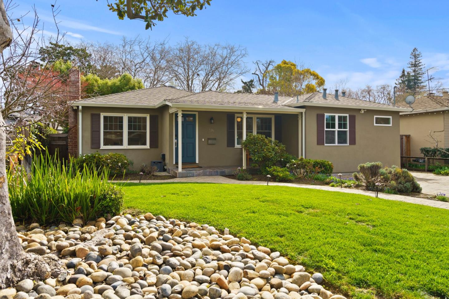 a front view of a house with garden