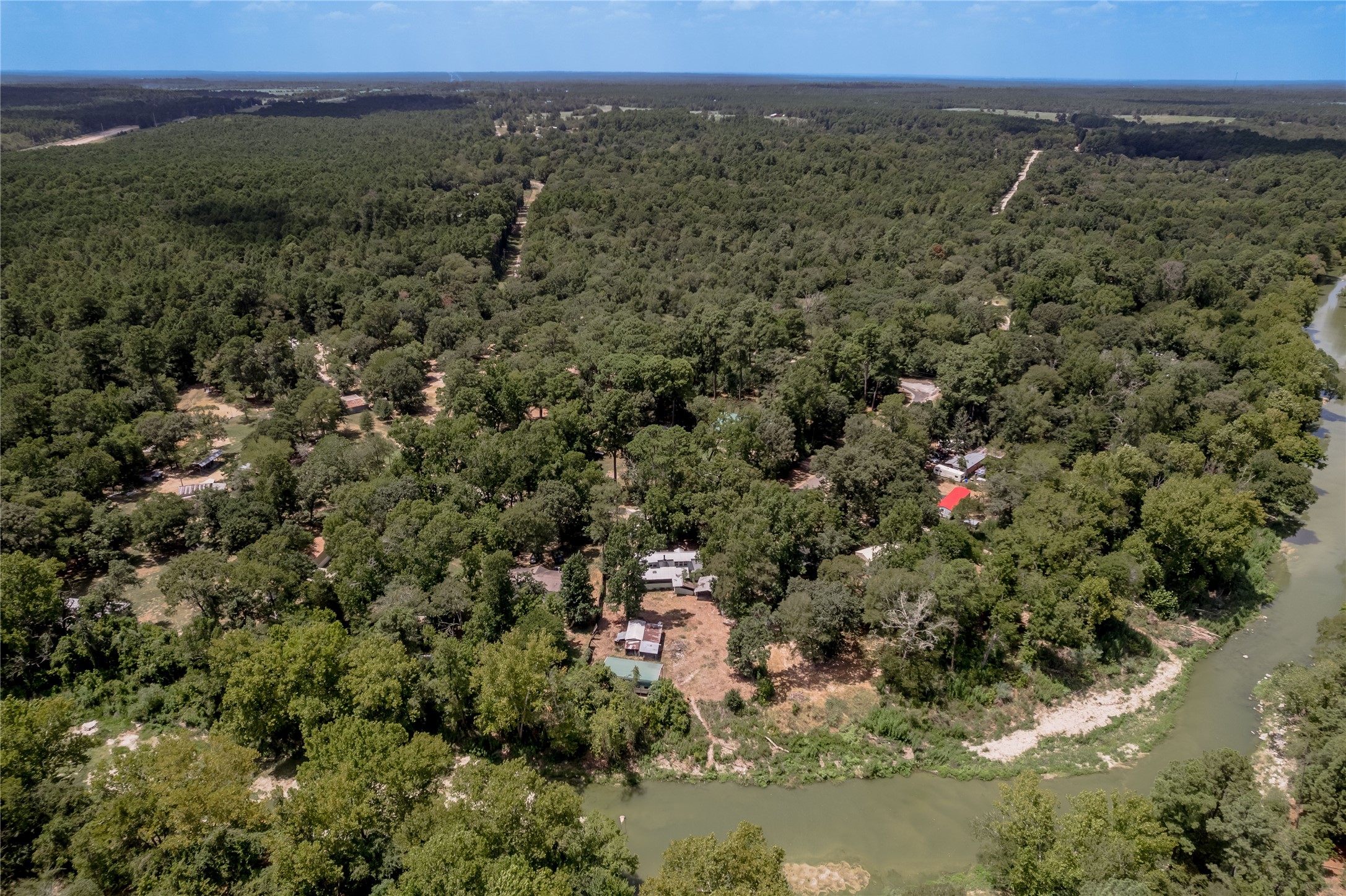 8 Creek Road Huntsville, TX 77320 - Photo 44 of 50 Nestled in a lush, forested landscape, this property offers serene riverfront views, perfect for nature lovers seeking tranquility and privacy.