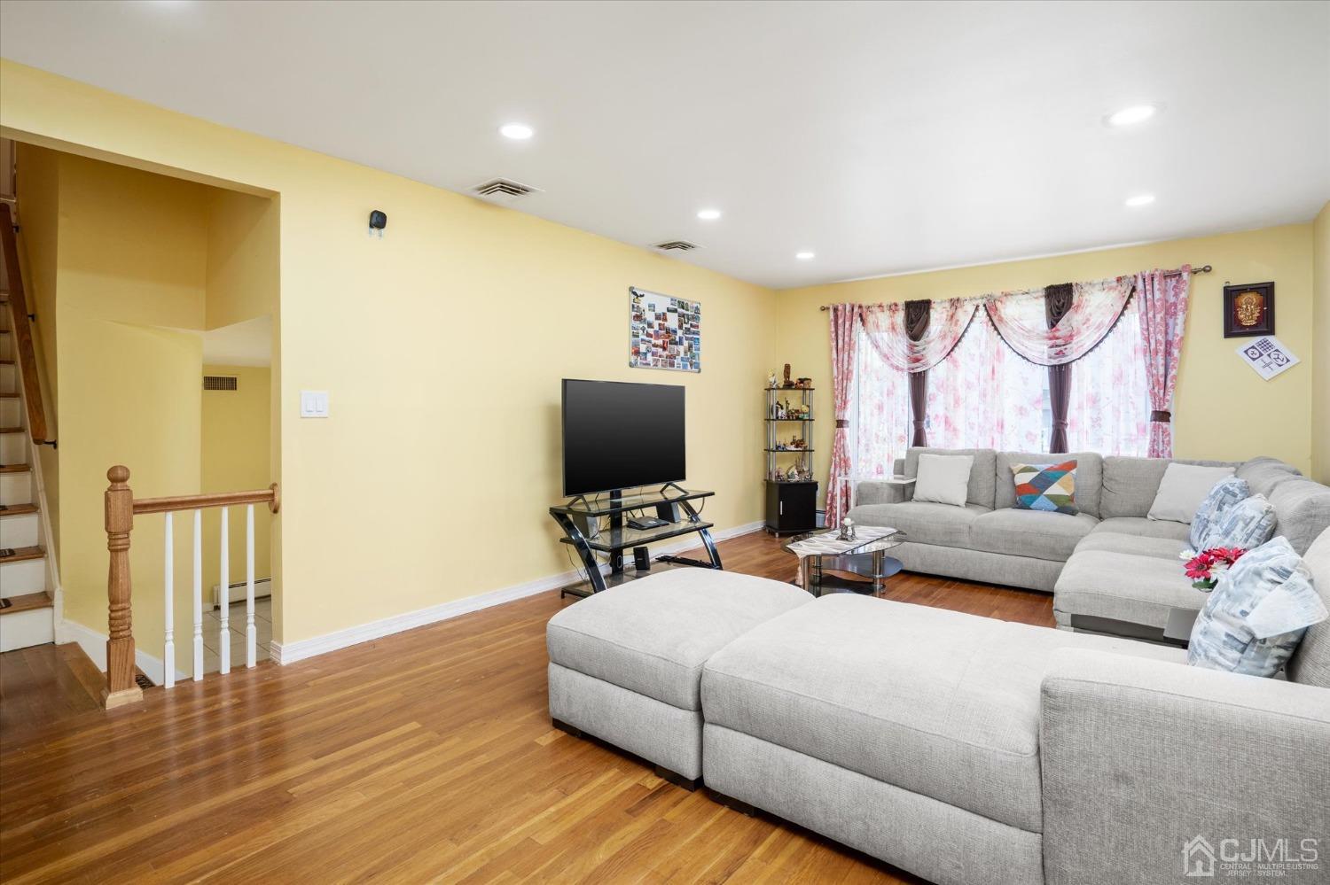 39 Lynnwood Road Edison, NJ 08820 - Photo 11 of 32 a living room with furniture and a flat screen tv