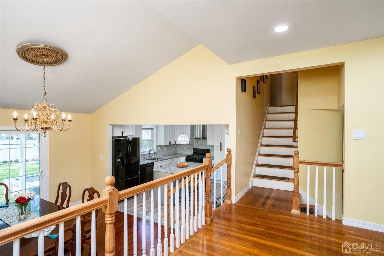 39 Lynnwood Road Edison, NJ 08820 - Photo 13 of 32 a view of a hallway to room with wooden floor and staircase