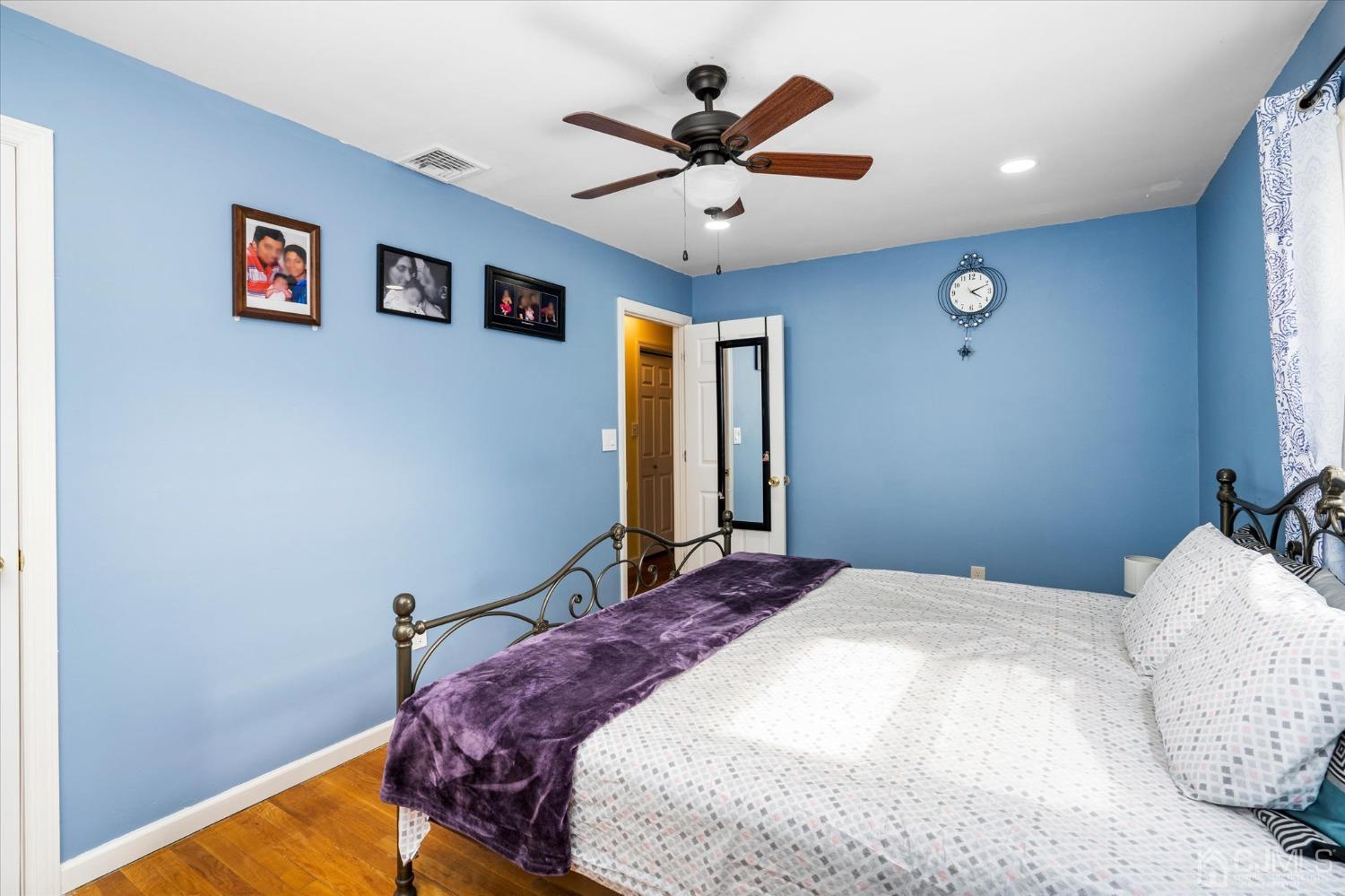 39 Lynnwood Road Edison, NJ 08820 - Photo 20 of 32 a bedroom with a large bed and a ceiling fan