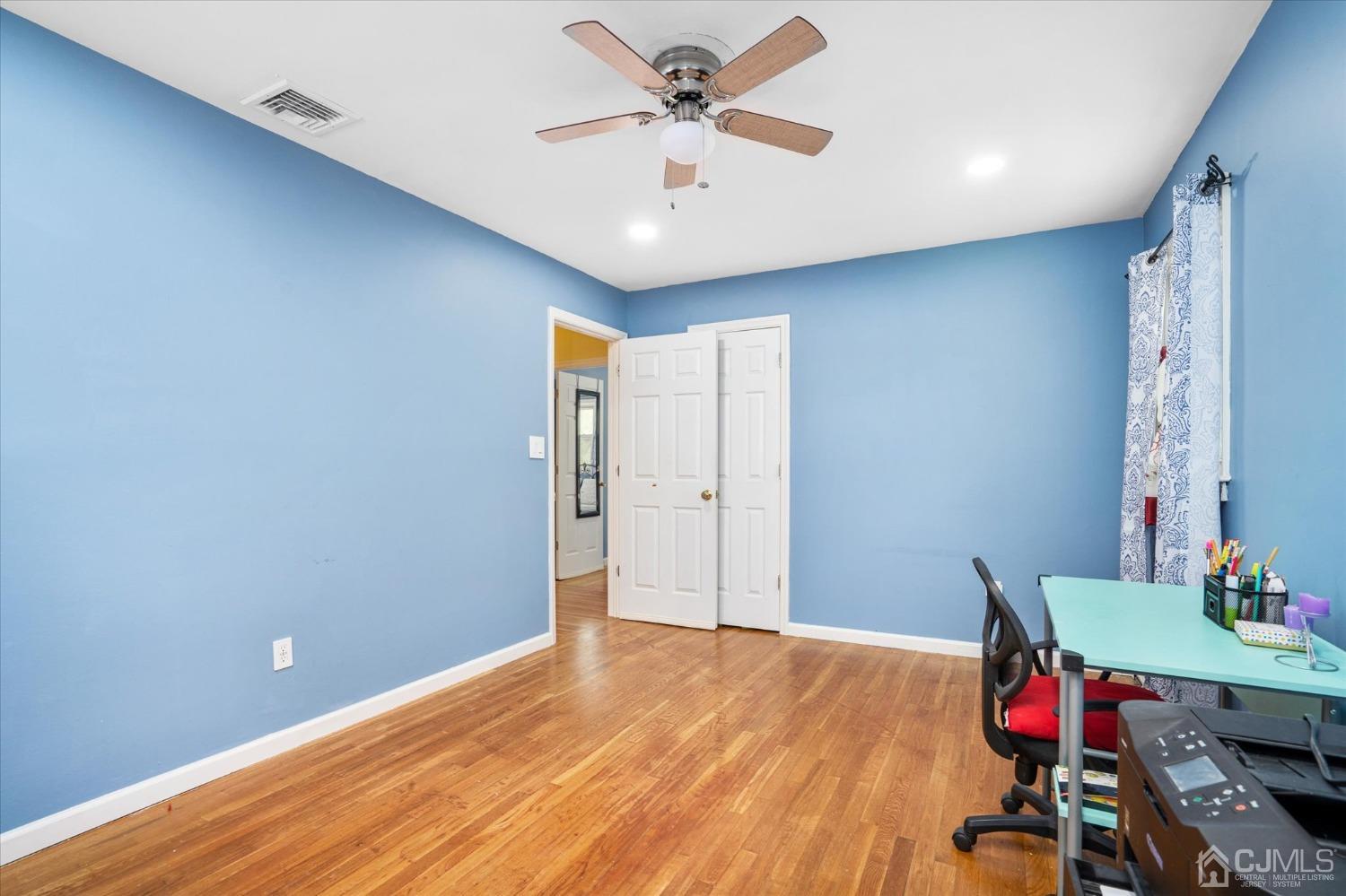 39 Lynnwood Road Edison, NJ 08820 - Photo 22 of 32 a view of room with hardwood floor and ceiling fan