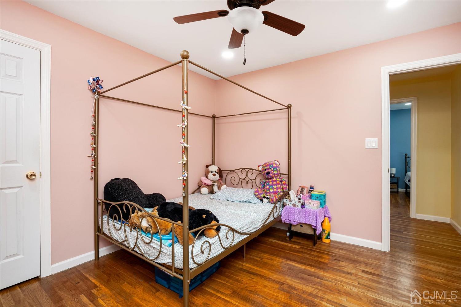 39 Lynnwood Road Edison, NJ 08820 - Photo 24 of 32 a bedroom with a bed and wooden floor