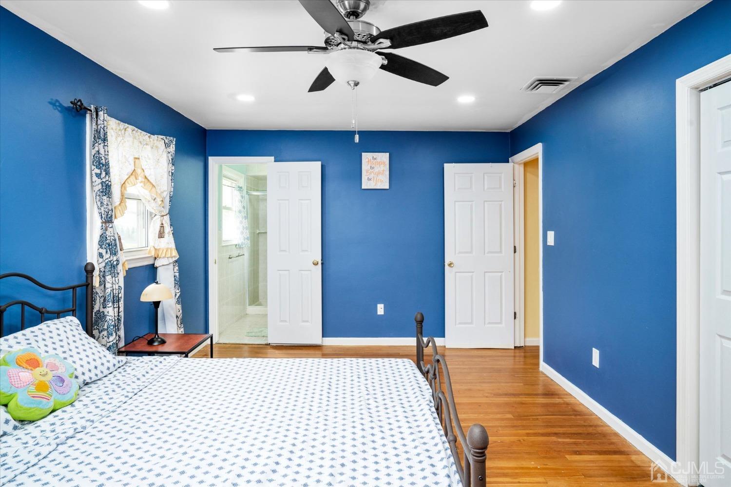 39 Lynnwood Road Edison, NJ 08820 - Photo 26 of 32 a bedroom with a bed and a chandelier