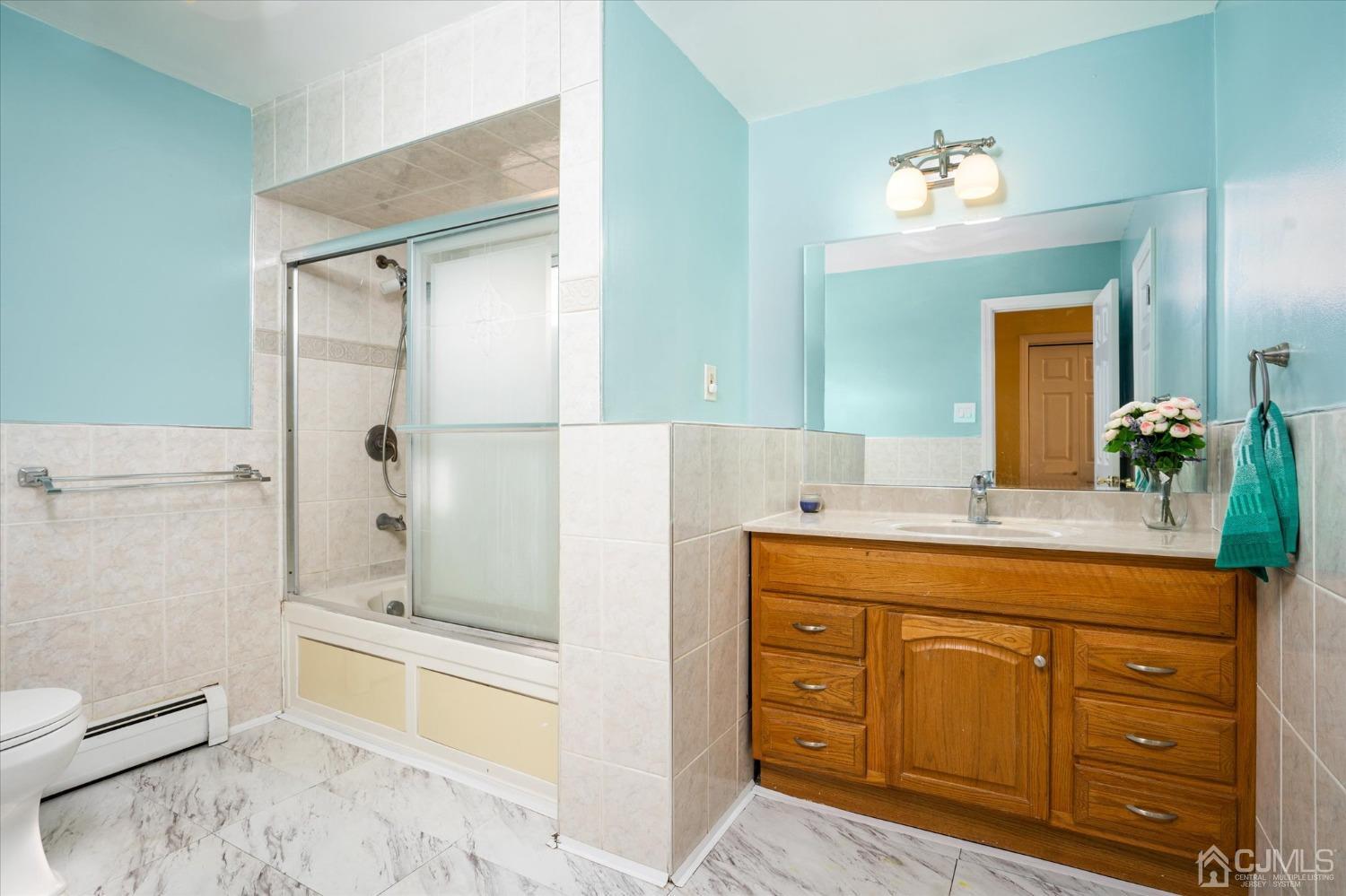 39 Lynnwood Road Edison, NJ 08820 - Photo 28 of 32 a bathroom with a granite countertop sink a toilet mirror and bathtub