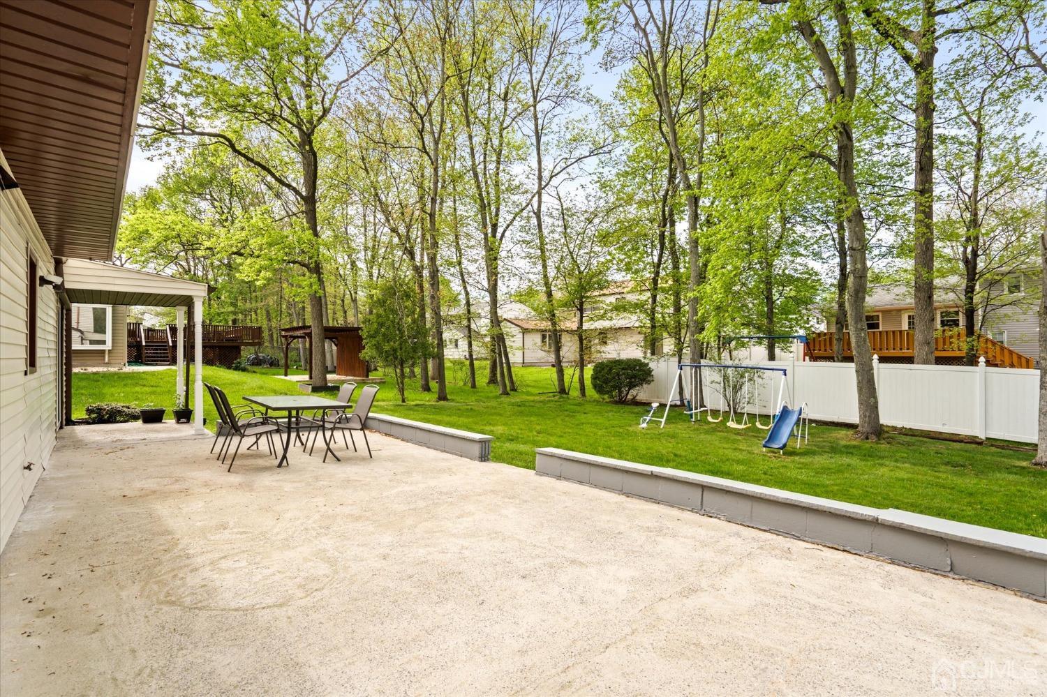 39 Lynnwood Road Edison, NJ 08820 - Photo 30 of 32 a view of a park with large trees and a bench