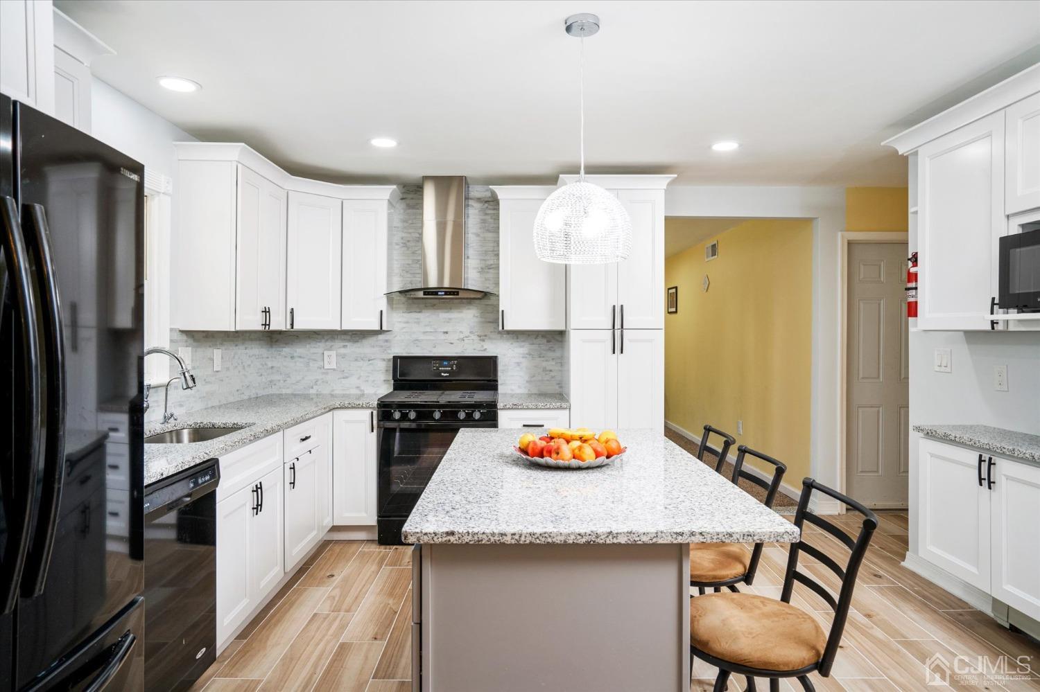 39 Lynnwood Road Edison, NJ 08820 - Photo 5 of 32 a kitchen with stainless steel appliances granite countertop a sink refrigerator and cabinets