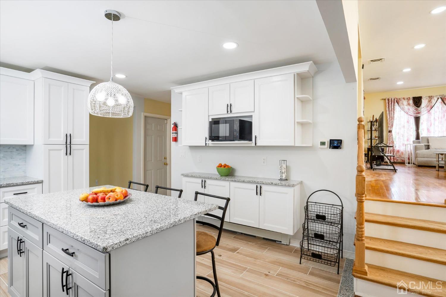 39 Lynnwood Road Edison, NJ 08820 - Photo 6 of 32 a kitchen with granite countertop a table chairs stove and cabinets