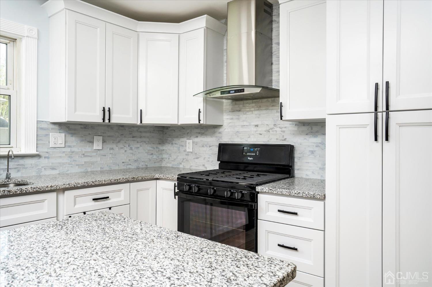 39 Lynnwood Road Edison, NJ 08820 - Photo 8 of 32 a kitchen with granite countertop a stove a sink and a granite counter tops