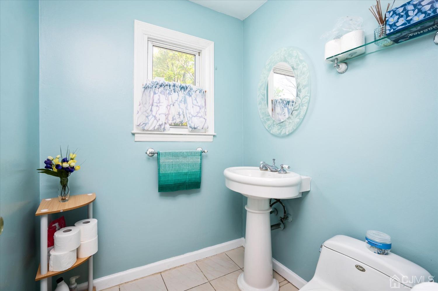 39 Lynnwood Road Edison, NJ 08820 - Photo 9 of 32 a bathroom with a sink a mirror and a toilet