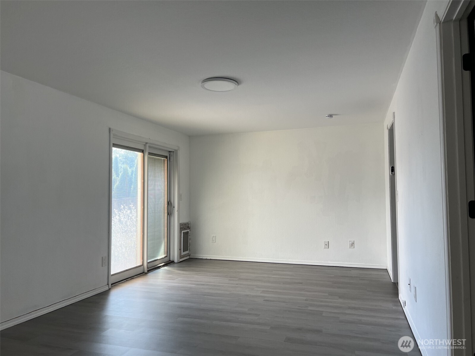 1124 Pinedrop Loop Southeast Olympia, WA 98513 - Photo 6 of 20 a view of an empty room with wooden floor and closet