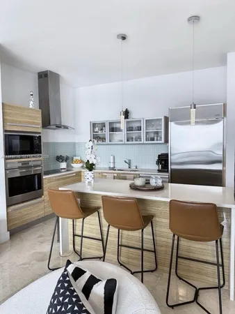 a kitchen with stainless steel appliances kitchen island granite countertop a sink and a stove