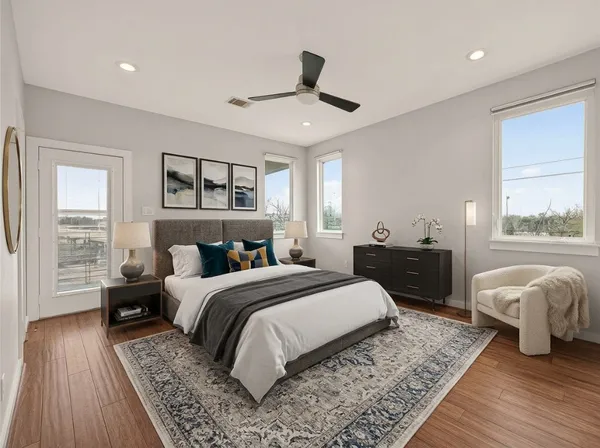 a view of empty room with wooden floor and ceiling fan