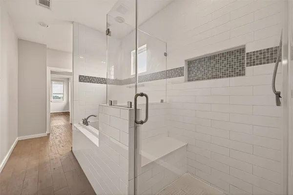 a bathroom with a bathtub and a shower