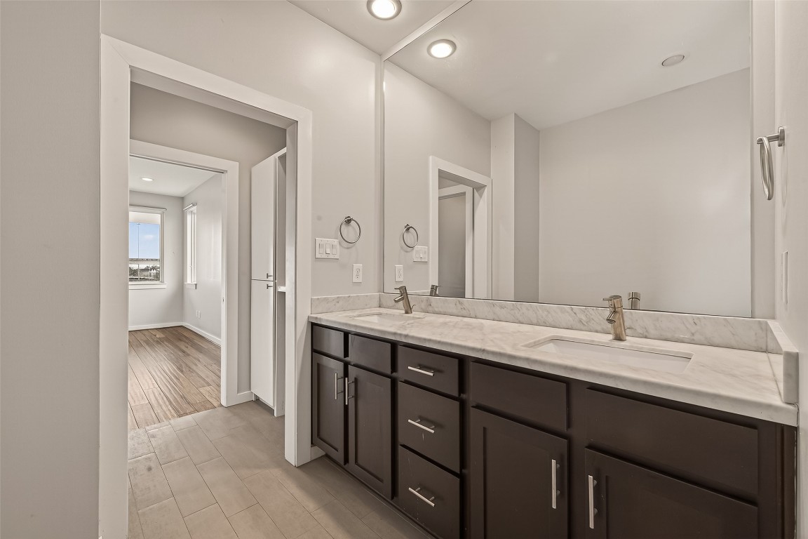 1819 South Street Houston, TX 77009 - Photo 22 of 27 a spacious bathroom with a granite countertop sink and a mirror