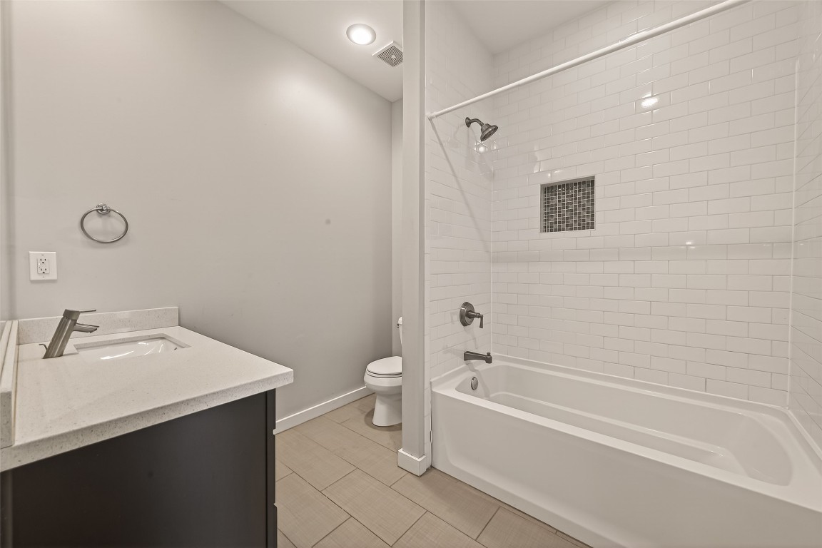 1819 South Street Houston, TX 77009 - Photo 7 of 27 a bathroom with a bathtub shower sink vanity and toilet