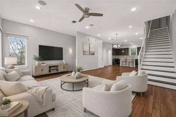 a kitchen with stainless steel appliances wooden floor sink and wooden cabinets