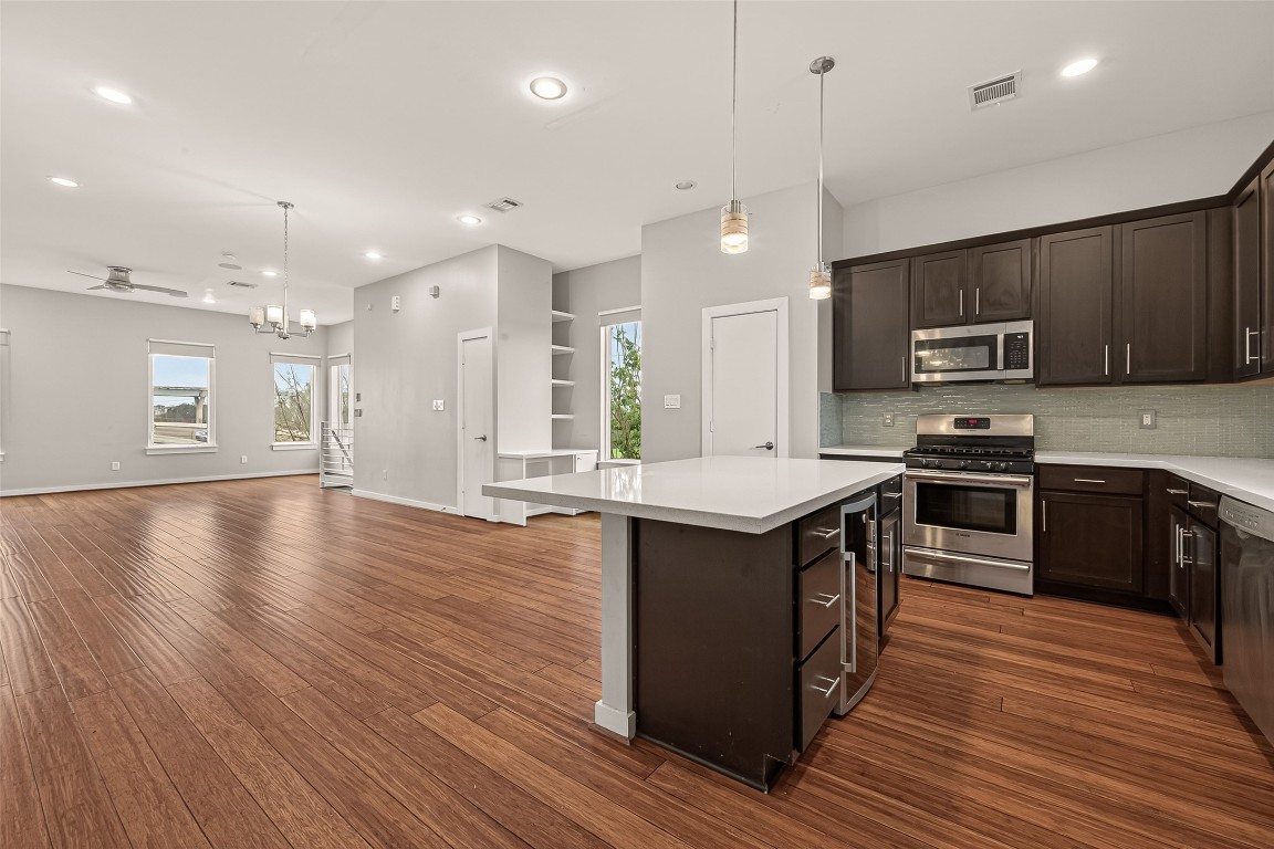 1819 South Street Houston, TX 77009 - Photo 10 of 27 a kitchen with stainless steel appliances granite countertop a stove a sink and a refrigerator