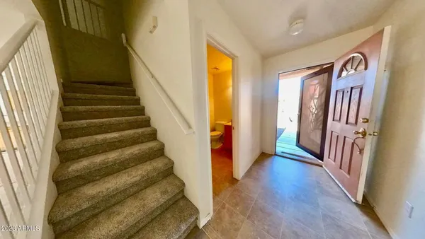 a view of a hallway with wooden floor and windows