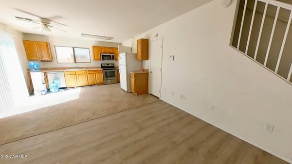 a view of a kitchen with wooden floor and a kitchen