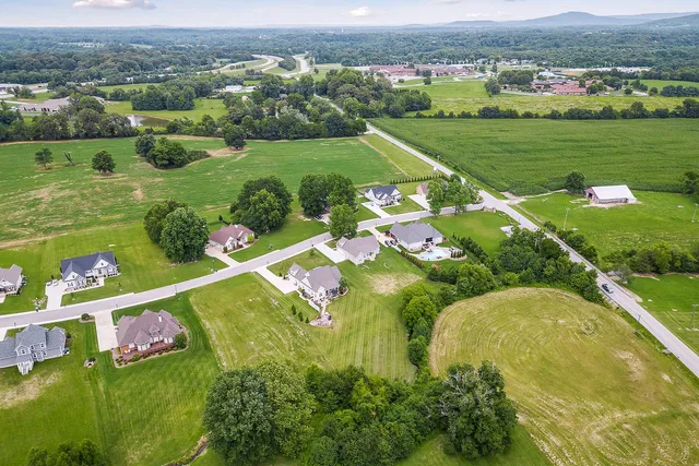 an aerial view of a golf course with parking space