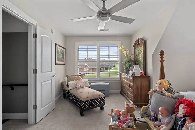 a bedroom with furniture and a large window