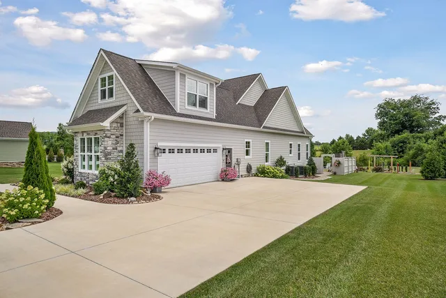 a front view of a house with a yard and garage