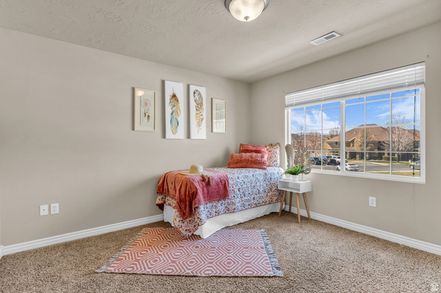 1136 West Spencer Road, Unit Y203 Pleasant Grove, UT 84062 - Photo 18 of 26 Carpeted bedroom with baseboards and a textured ceiling