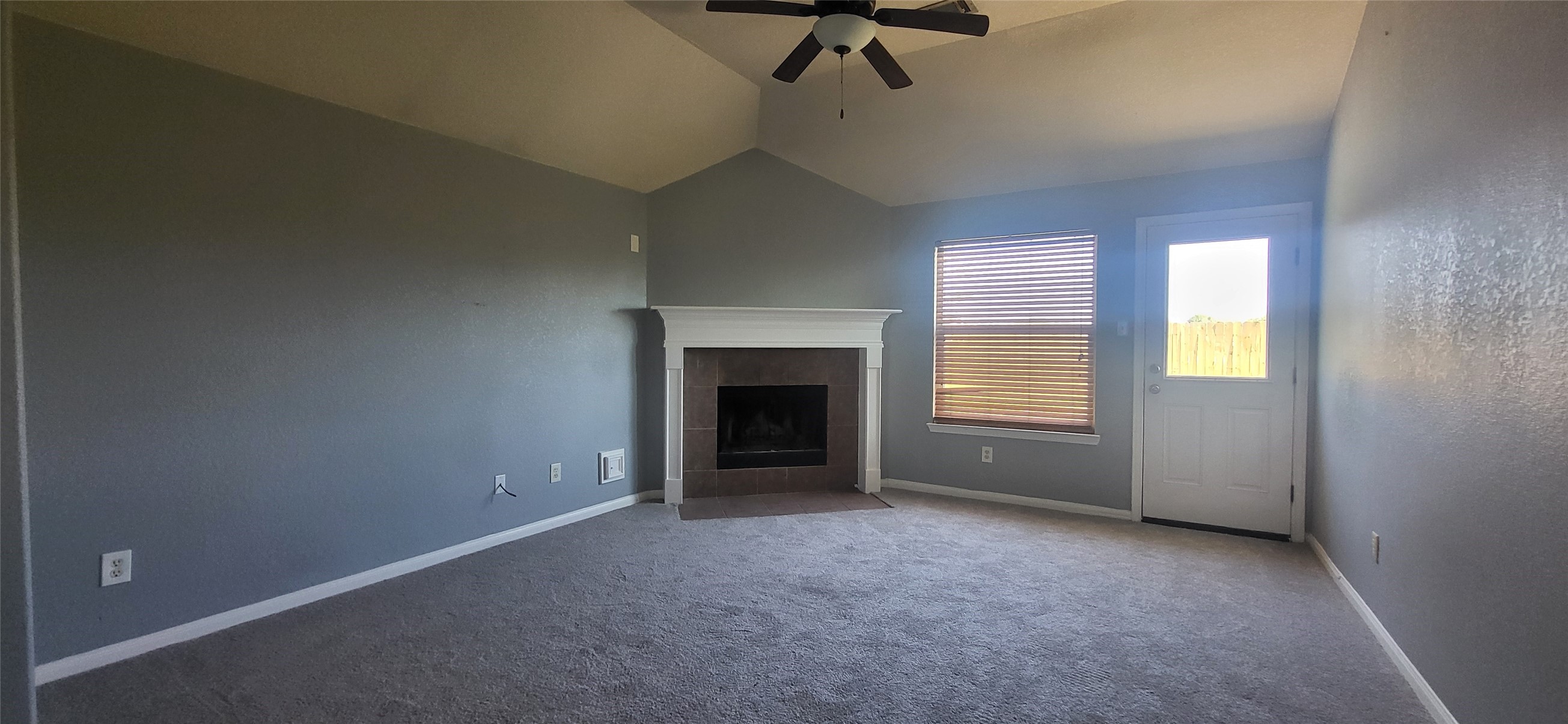 24022 Rockygate Drive Spring, TX 77373 - Photo 2 of 12 a view of an empty room with a fireplace and a window