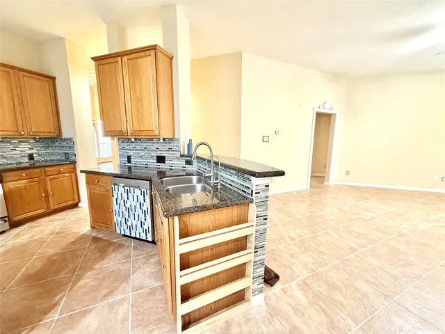 a kitchen with stainless steel appliances granite countertop a sink and a stove