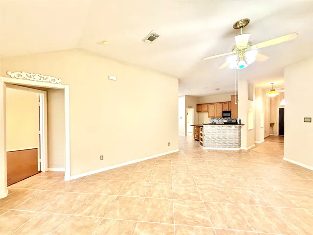 a view of a kitchen with kitchen island and stainless steel appliances