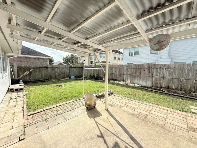 a view of a backyard with table and chairs